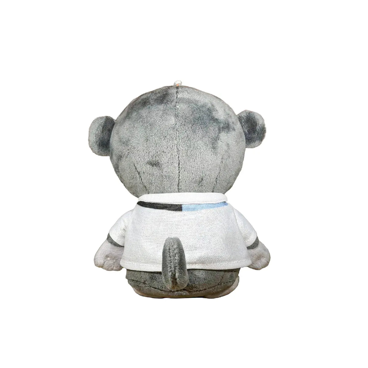 A plush monkey toy wearing a white shirt with black circular graphics and a small blue accent, photographed against a plain white background.