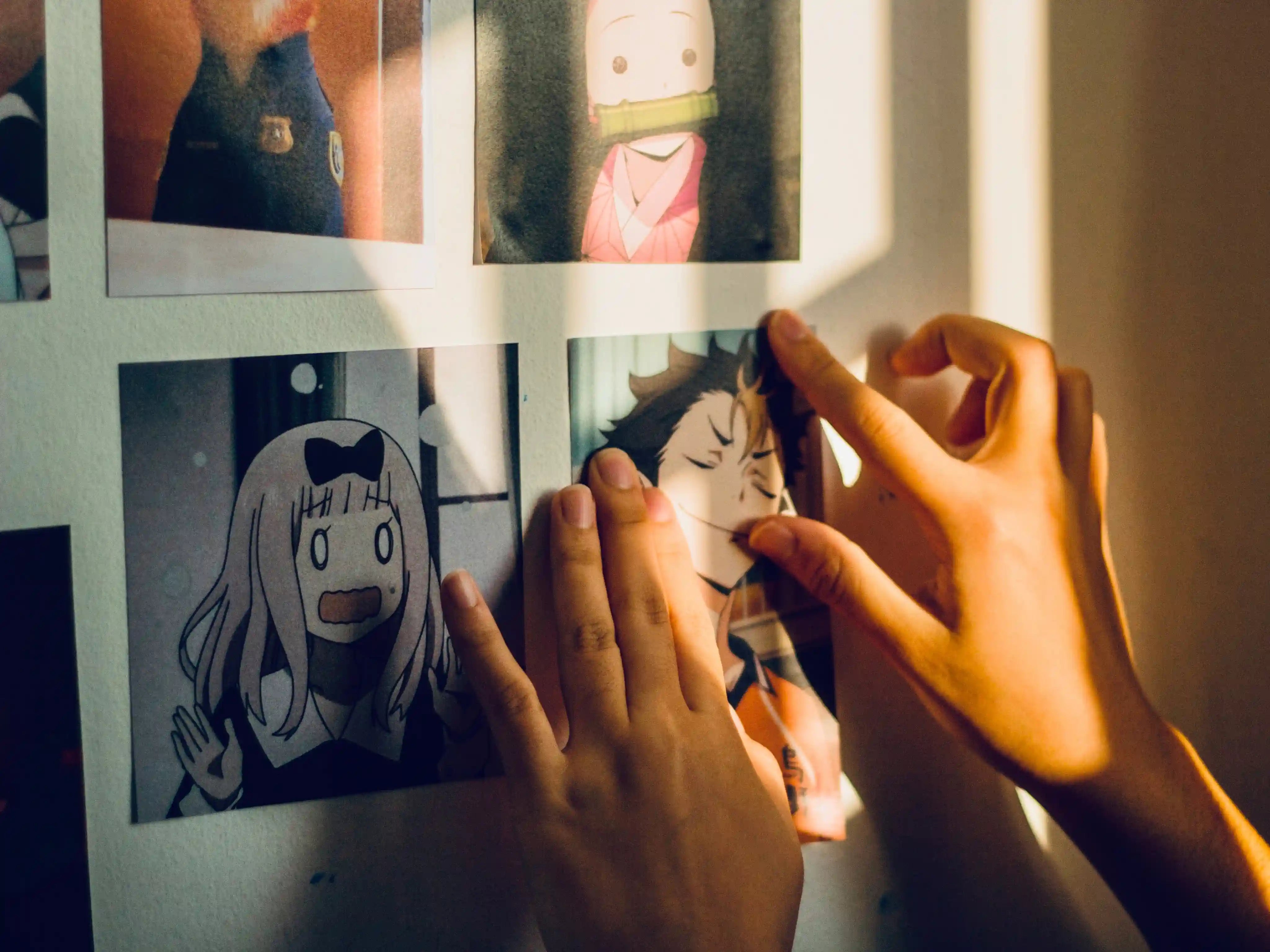 Person Sticking Image On The Wall